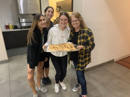 Wendi Highland serving homemade cookies to a few of the members of Alpha Phi in Tucson. Photo by Zoe Roberts.