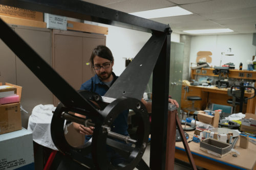 Fuls inspects a new mount that will be used for a telescope camera that he and another astronomer, Steve Larson, are renovating.