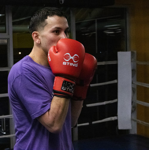 Jaime Cuesta, a young amateur boxer, gets ready to start his night training for an upcoming tournament. Cuesta spends around 4-6 hours a day practicing his boxing. (Photo by Madeleine Viceconte)